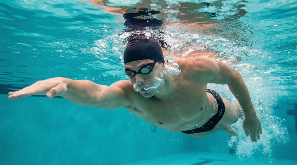 سباح يخرج الهواء تحت الماء أثناء السباحة لتحسين التحكم في التنفس
